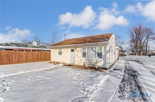 view of snow covered rear of property