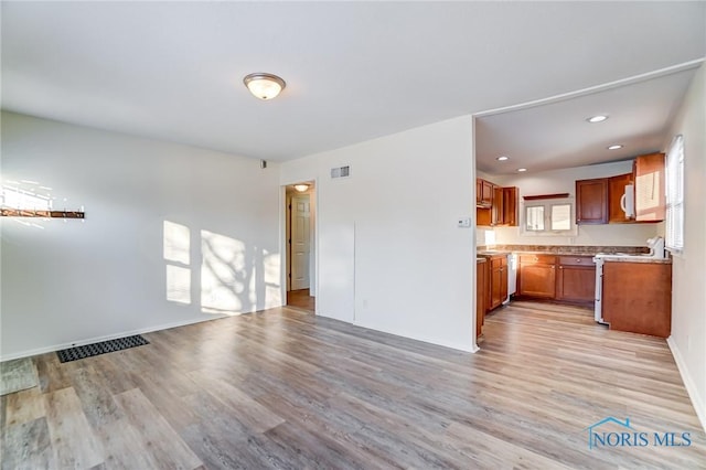 unfurnished living room with light hardwood / wood-style floors