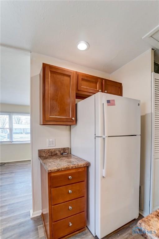 kitchen featuring light wood-type flooring and white fridge