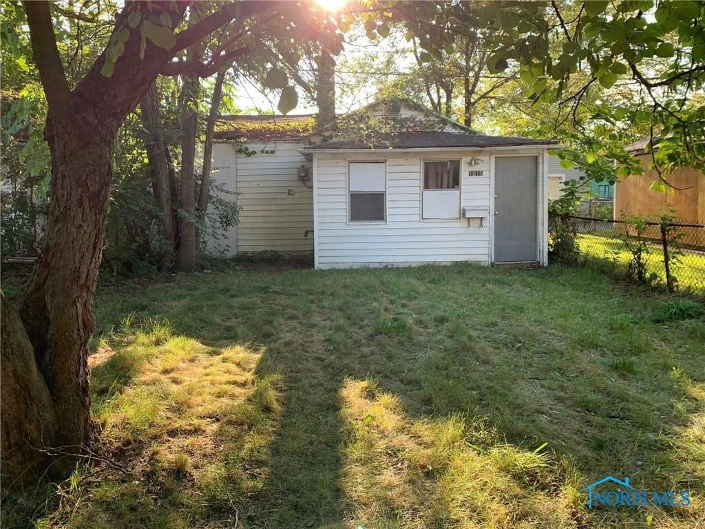 view of outdoor structure featuring a lawn