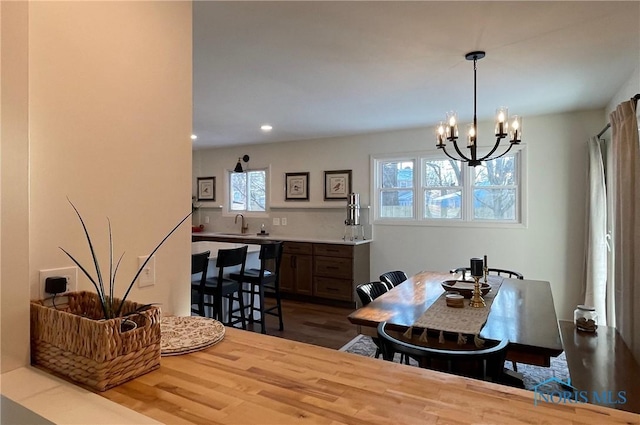 dining space with wood-type flooring and a chandelier