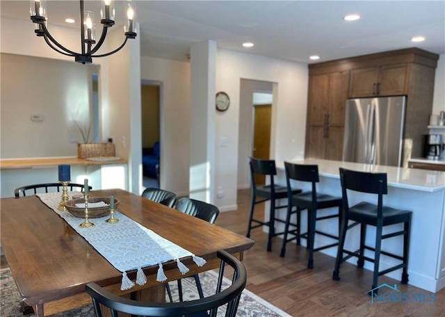 dining room featuring dark hardwood / wood-style flooring and a notable chandelier