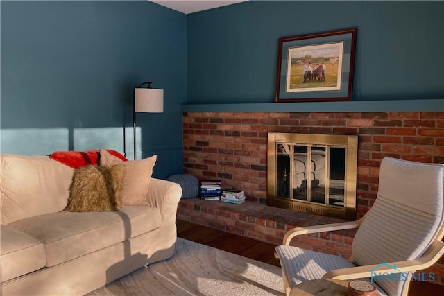 living room featuring a brick fireplace