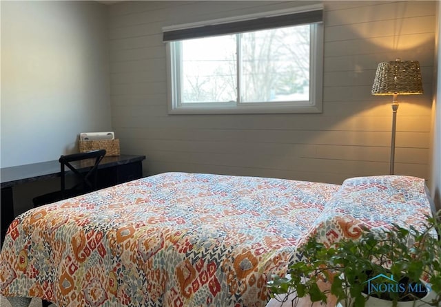 bedroom with wooden walls