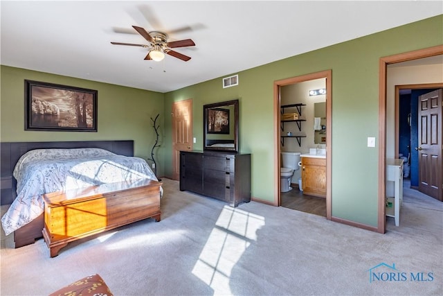 carpeted bedroom with connected bathroom and ceiling fan