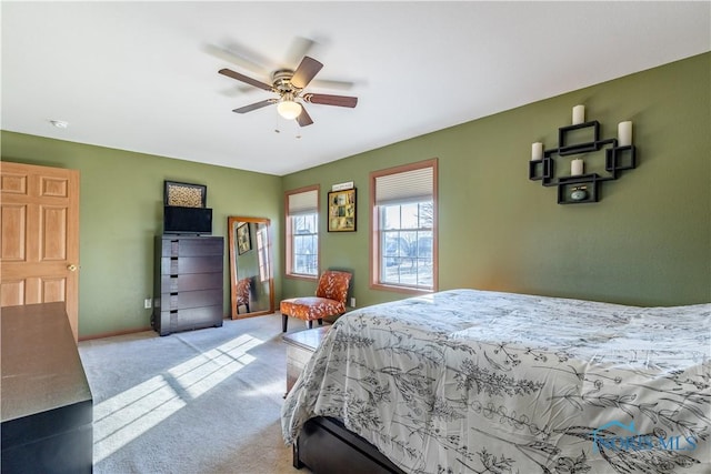 bedroom with ceiling fan and light carpet