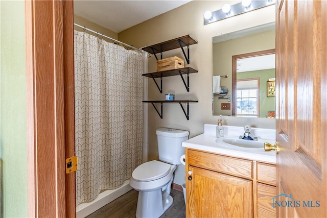 bathroom featuring vanity, hardwood / wood-style flooring, and toilet