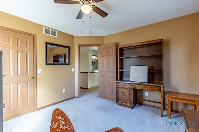 carpeted home office with ceiling fan