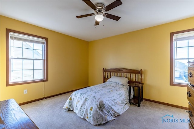 bedroom with light colored carpet and ceiling fan