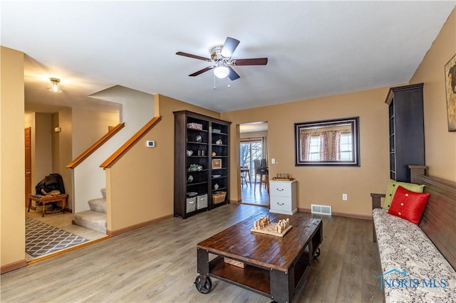 living room with wood-type flooring and ceiling fan