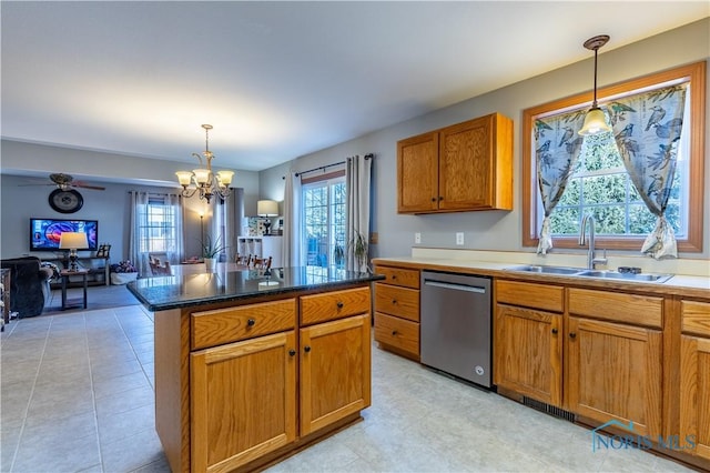 kitchen with sink, decorative light fixtures, a chandelier, a center island, and dishwasher