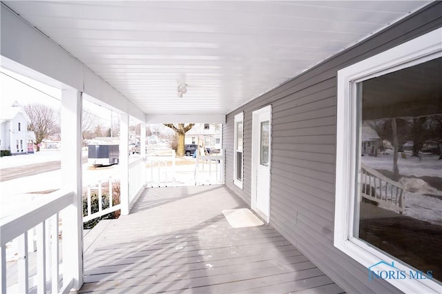 snow covered deck with covered porch