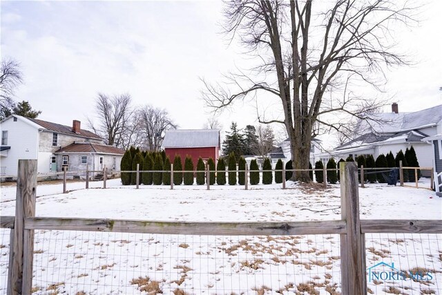 snowy yard with fence