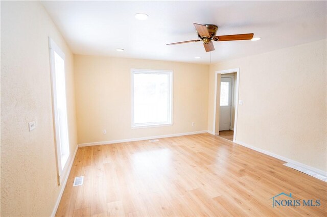 spare room featuring recessed lighting, visible vents, light wood-style floors, a ceiling fan, and baseboards