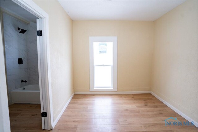 empty room featuring light wood-style flooring and baseboards