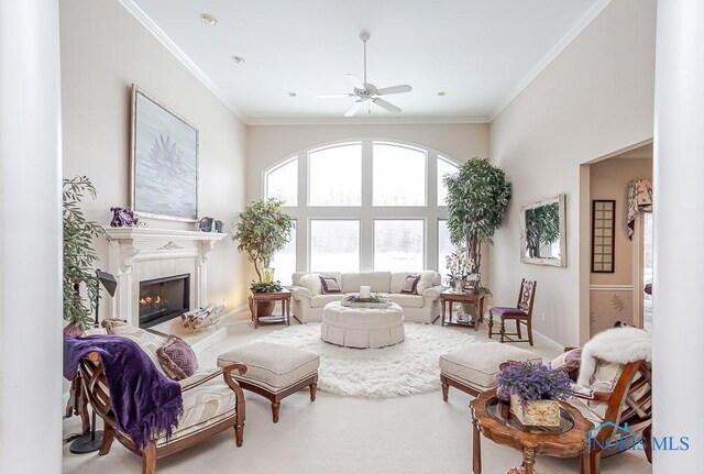 living room featuring crown molding, ceiling fan, and carpet