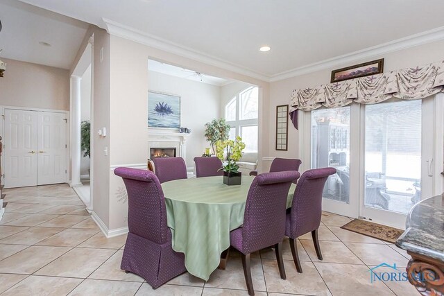 dining space with ornamental molding and light tile patterned floors