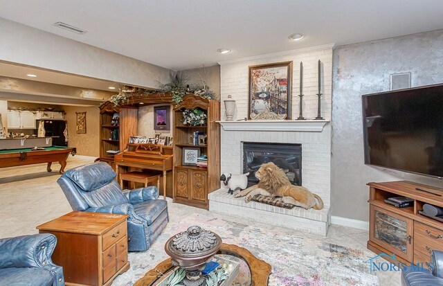 living room featuring a fireplace and pool table