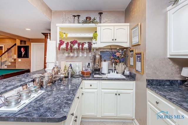 kitchen with white cooktop, sink, white cabinets, billiards, and light tile patterned flooring