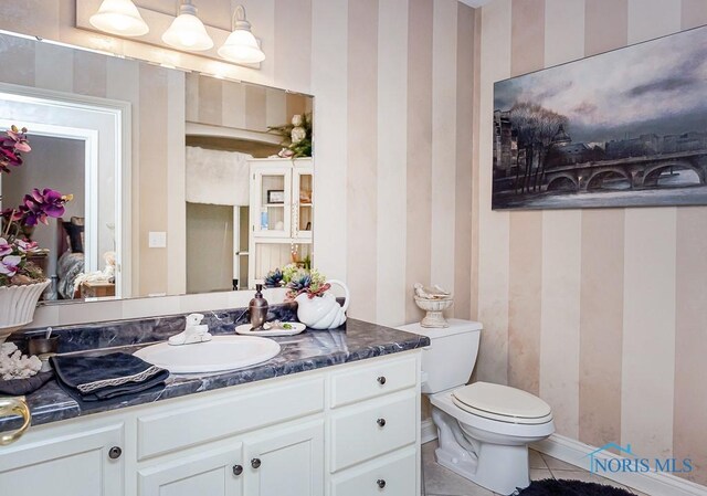 bathroom featuring tile patterned floors, toilet, and vanity