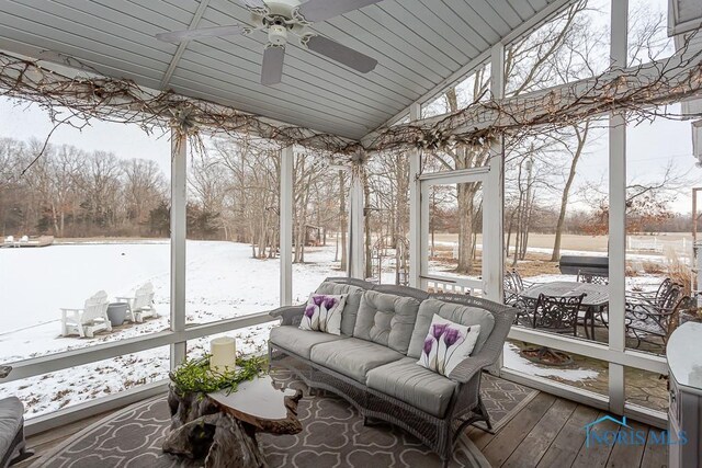 sunroom / solarium with a healthy amount of sunlight, vaulted ceiling, and ceiling fan