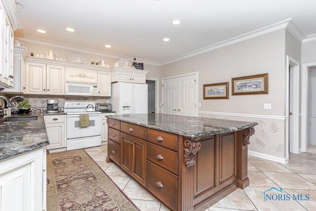 kitchen with sink, white appliances, a center island, and crown molding