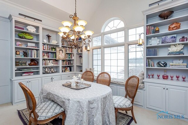 dining room with light carpet, an inviting chandelier, and high vaulted ceiling