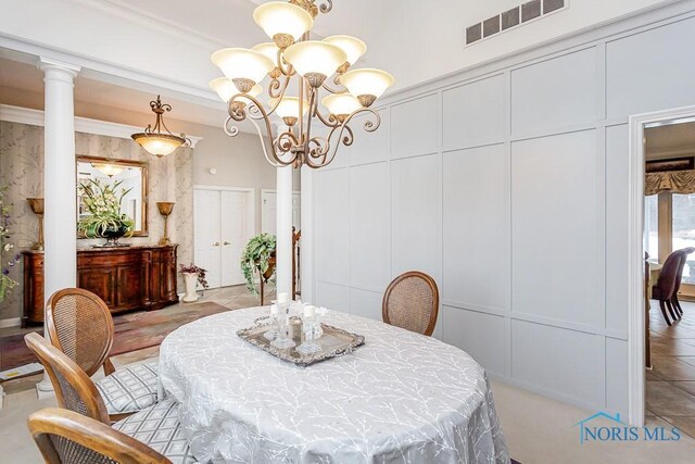 dining area with decorative columns and a notable chandelier