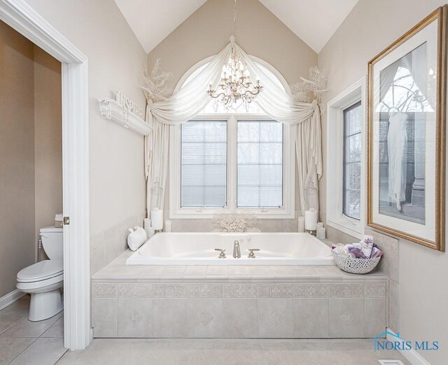 bathroom with a wealth of natural light, toilet, and lofted ceiling