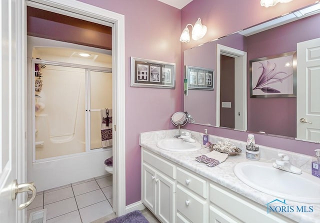 full bathroom with vanity, toilet, bath / shower combo with glass door, and tile patterned flooring