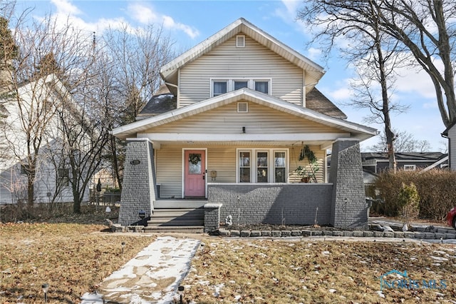 view of front of house with covered porch and brick siding