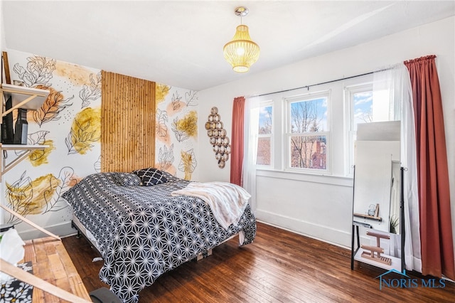 bedroom with wallpapered walls, wood-type flooring, and baseboards