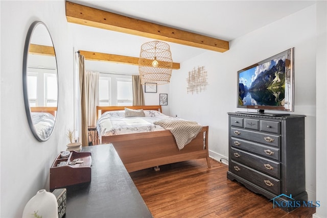 bedroom featuring dark wood-style floors, baseboards, and beamed ceiling