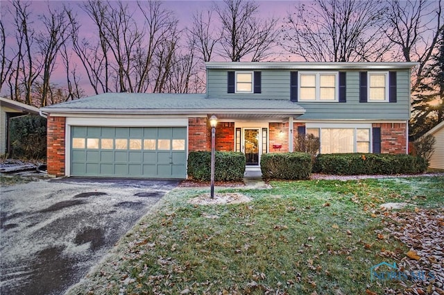 view of property with a garage and a yard