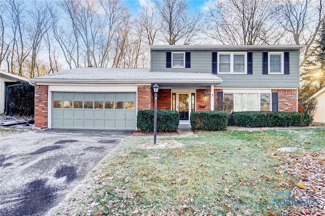 front facade featuring a front yard and a garage