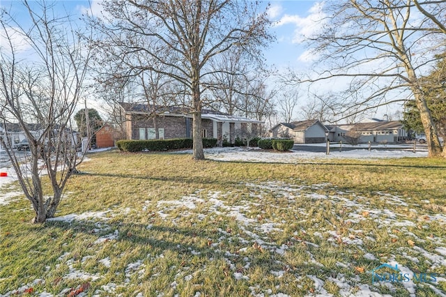 ranch-style home featuring a front yard