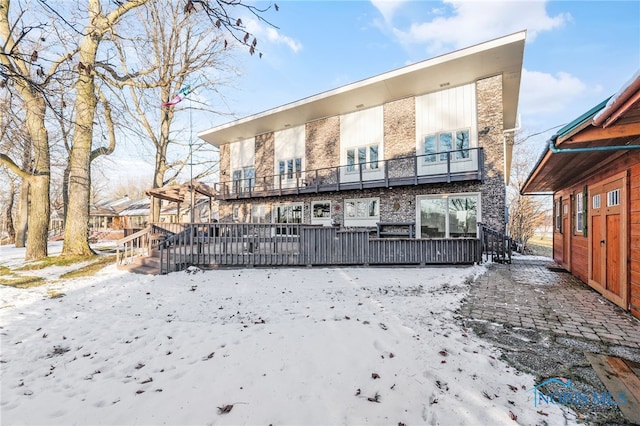 snow covered property featuring a wooden deck