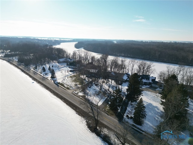 snowy aerial view featuring a water view