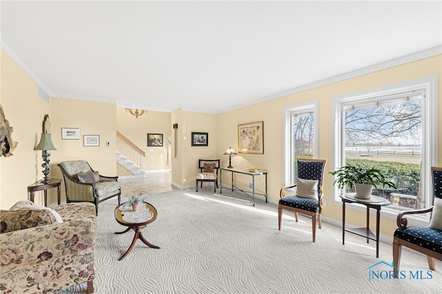 carpeted living room with crown molding