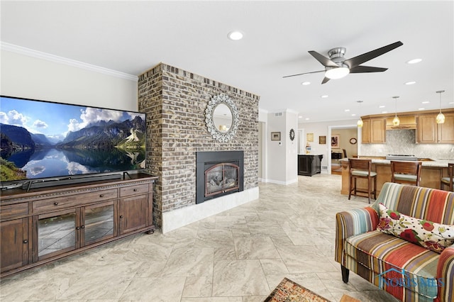 living room with ceiling fan, a brick fireplace, and ornamental molding