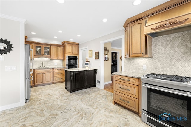 kitchen with light stone countertops, appliances with stainless steel finishes, tasteful backsplash, sink, and crown molding