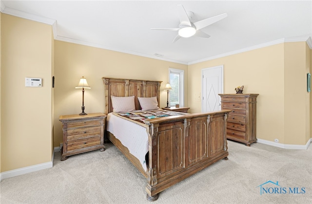 carpeted bedroom featuring ceiling fan and ornamental molding