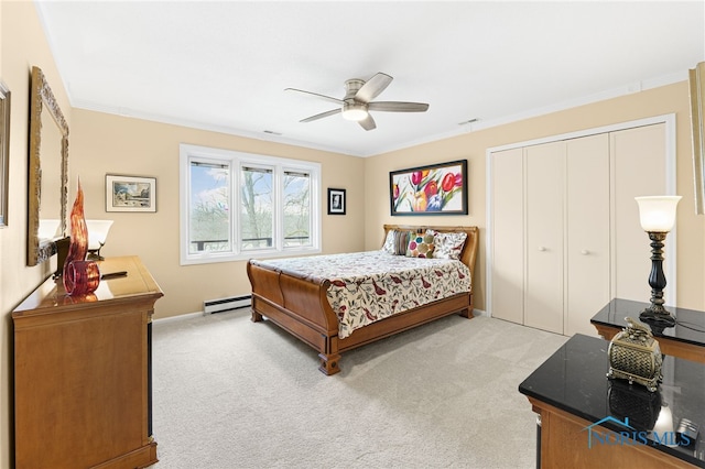 carpeted bedroom featuring ceiling fan, a baseboard heating unit, a closet, and ornamental molding