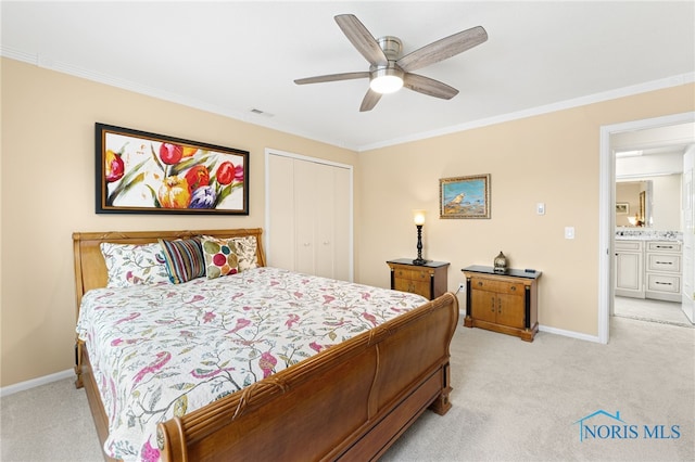 bedroom with ceiling fan, light colored carpet, a closet, and crown molding