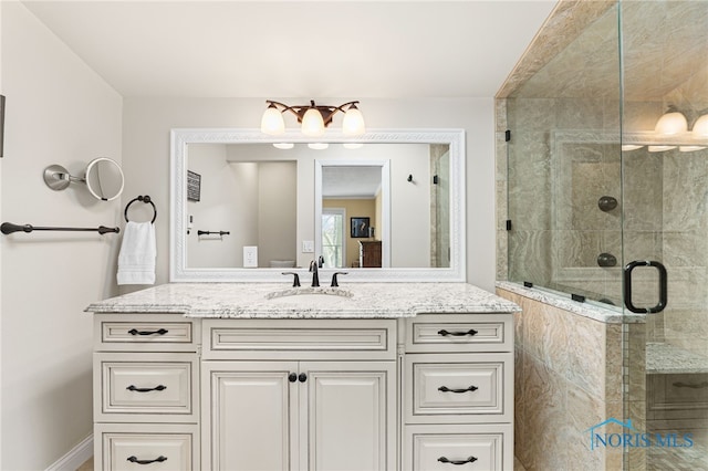 bathroom with walk in shower and vanity