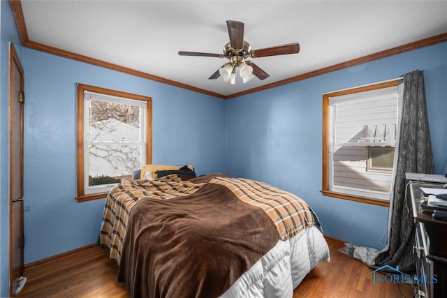 bedroom featuring ceiling fan, crown molding, and hardwood / wood-style floors