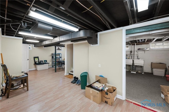 basement with hardwood / wood-style floors