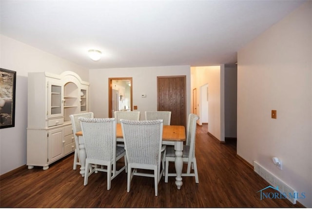 dining space with dark wood-type flooring