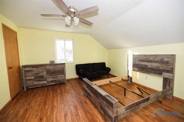 bedroom featuring vaulted ceiling, dark wood-type flooring, and ceiling fan