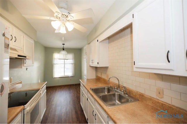 kitchen featuring sink, electric range, decorative light fixtures, and white cabinets